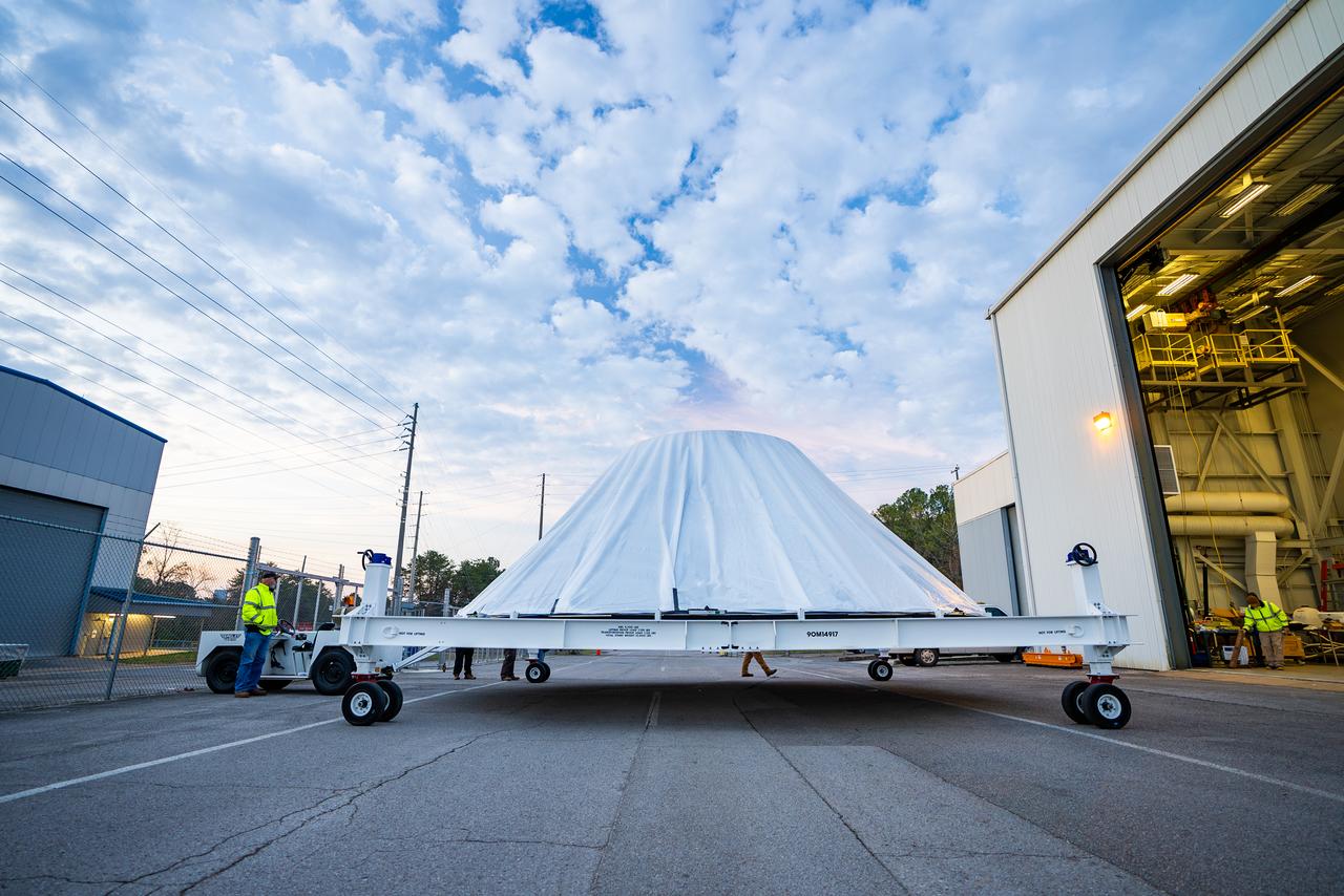 These photos and videos show how crews at NASA’s Marshall Space Flight Center in Huntsville, Alabama, moved and installed the payload adapter that will be used in the Block 1B configuration of the SLS (Space Launch System) rocket from Building 4708, where it was manufactured, into Structural Test Stand 4697 at NASA’s Marshall Space Flight Center on March 13. Teams at Marshall will begin structural testing the engineering development unit of the payload adapter – an exact replica of the flight version of the hardware – this spring. The cone-shaped payload adapter is about 8.5 feet tall and features two metal rings and eight composite panels. The adapter, which will debut on NASA’s Artemis IV mission, is an evolution from the Orion stage adapter used in the Block 1 configuration of the first three Artemis missions. It will be housed inside the universal stage adapter atop the rocket’s more powerful in-space stage, called the exploration upper stage. The payload adapter, like the launch vehicle stage adapter and the Orion stage adapter, is fully manufactured and tested at Marshall, which manages the SLS Program. NASA is working to land the first woman, first person of color, and its first international partner astronaut on the Moon under Artemis. SLS is part of NASA’s backbone for deep space exploration, along with the Orion spacecraft and Gateway in orbit around the Moon and commercial human landing systems, next-generational spacesuits, and rovers on the lunar surface. SLS is the only rocket that can send Orion, astronauts, and supplies to the Moon in a single launch.